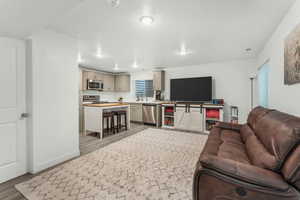 Living room with sink and light wood-type flooring