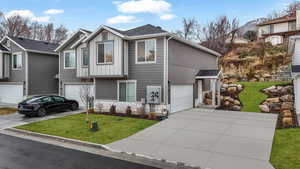 View of front of home featuring a garage and a front yard