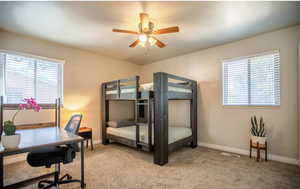 Bedroom featuring ceiling fan and light carpet