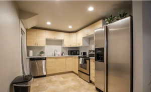 Kitchen featuring sink, stainless steel appliances, and light brown cabinets