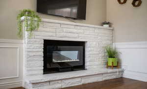 Details with hardwood / wood-style flooring and a fireplace