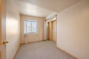 bedroom with light carpet and a textured ceiling