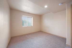 Carpeted bedroom with a textured ceiling