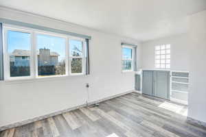 Unfurnished room with light wood-type flooring