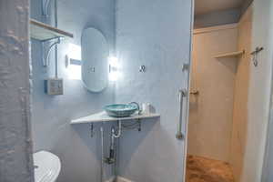 Bathroom featuring concrete flooring and sink