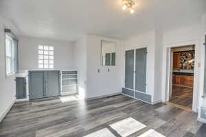 Interior space with dark hardwood / wood-style flooring