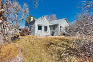 View of property exterior featuring a lawn