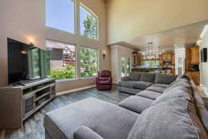 Living room featuring hardwood / wood-style flooring and a towering ceiling