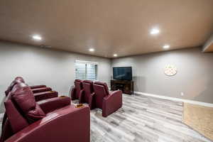 Living room featuring a textured ceiling and light wood-type flooring