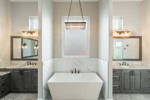 Bathroom featuring vanity and a bathtub