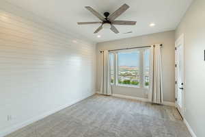 Unfurnished room with light carpet and ceiling fan