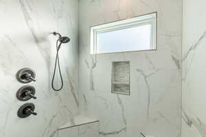 Bathroom featuring a tile shower