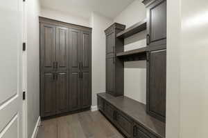 Mudroom featuring a textured ceiling and dark hardwood / wood-style flooring