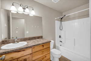 Full bathroom with vanity, toilet, and washtub / shower combination