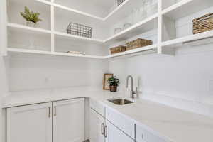 Kitchen with white cabinetry and sink