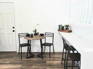 Dining room featuring lofted ceiling, a notable chandelier, and dark hardwood / wood-style flooring