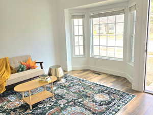 Sitting room with a chandelier and hardwood / wood-style floors