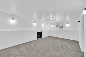 Carpeted empty room with a textured ceiling