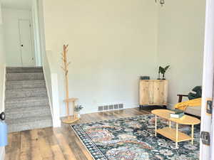 Sitting room with an inviting chandelier and hardwood / wood-style floors