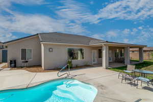 Back of house featuring cooling unit and a patio area