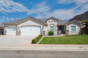 View of front of home featuring a garage and a front lawn