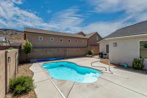 View of swimming pool with a patio area