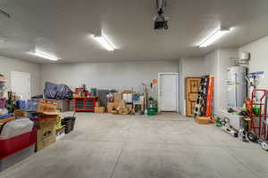 Garage with a garage door opener and electric water heater