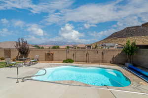 View of swimming pool with a mountain view and a patio area