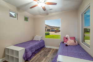 Bedroom featuring dark wood-type flooring and ceiling fan