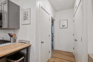 Hallway with light wood-type flooring