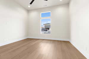 Empty room with light hardwood / wood-style floors and ceiling fan