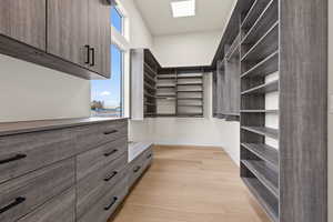 Walk in closet featuring light wood-type flooring