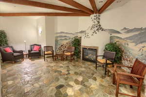 Living area featuring beam ceiling