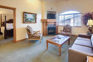 Living room with a tiled fireplace and carpet floors