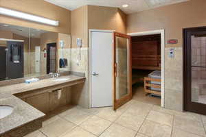 Bathroom featuring tile walls, sink, and tile patterned floors