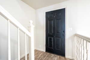 Foyer entrance featuring baseboards and wood finished floors