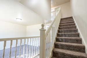 Staircase featuring carpet floors and baseboards