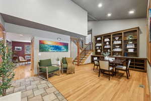 Dining area featuring light hardwood / wood-style floors and a high ceiling