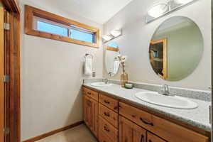 Bathroom featuring vanity and vaulted ceiling