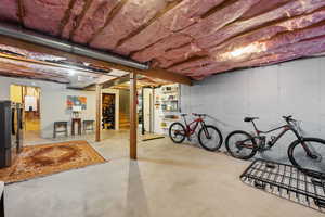 Basement with stainless steel refrigerator