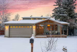 View of front facade featuring a garage and covered porch