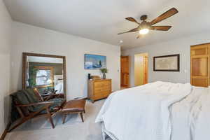 Carpeted bedroom with ceiling fan