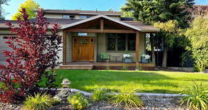 View of front of house featuring covered porch and a front lawn