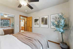 Carpeted bedroom featuring a closet and ceiling fan