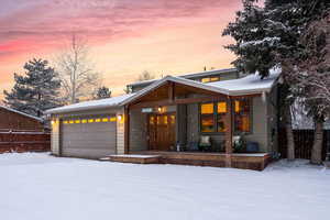 Modern home featuring a porch and a garage