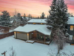 Snow covered house with a garage