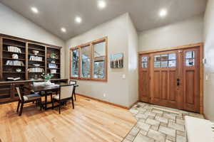 Entryway featuring plenty of natural light, light hardwood / wood-style floors, and vaulted ceiling