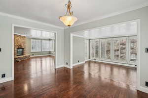 Sunroom featuring lots of windows, plantation shutters, and a door to hot tub area