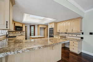 Kitchen with work desk, double ovens, walk in pantry