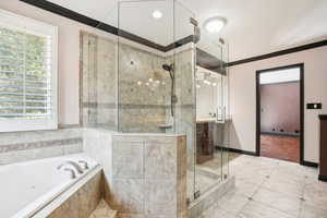 Master Bathroom featuring jetted corner tub, plantation shutters, large walk in shower, his and her vanities